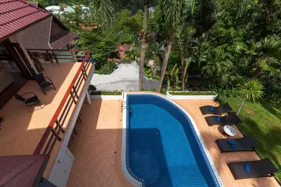 an overhead view of a swimming pool with loungers and a resort at Patong Hill Estate 6 in Patong Beach