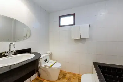 a bathroom with a toilet and a sink and a mirror at Patong Hill Estate 6 in Patong Beach