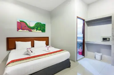 a bedroom with a bed with hello kitty shoes on it at Freedom Hotel in Patong Beach