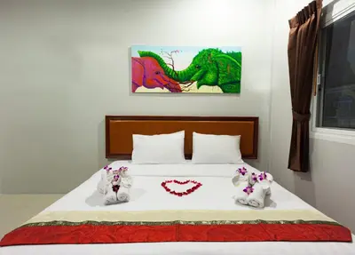 a bed with two stuffed animals on top of it at Freedom Hotel in Patong Beach