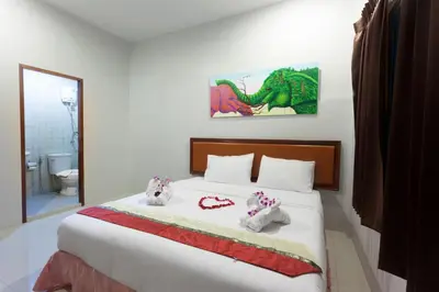a bedroom with a bed with two stuffed animals on it at Freedom Hotel in Patong Beach