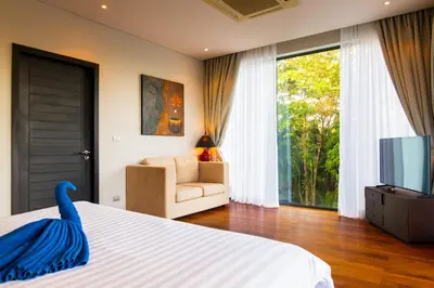 a bedroom with a bed with a blue swan on it at Amazing 5br, Seaview private PoolVilla by Intira Villas in Rawai Beach
