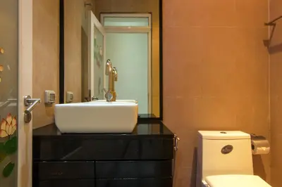 a bathroom with a sink and a toilet at Amazing 5br, Seaview private PoolVilla by Intira Villas in Rawai Beach
