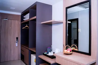 a bathroom with a large mirror and a sink at Casa Del M Patong Phuket in Patong Beach