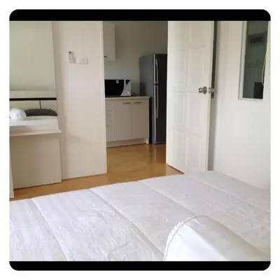 a white bedroom with a white bed and a kitchen at Apartment in Ranghill Residence Phuket by month in Phuket Town