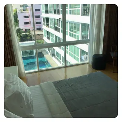 a bedroom with a bed and a large window at Apartment in Ranghill Residence Phuket by month in Phuket Town