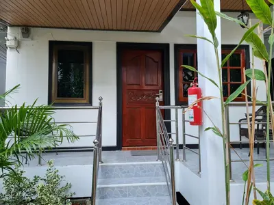 a front door of a house with a red fire hydrant at Momento Bangtao Beach in Bang Tao Beach