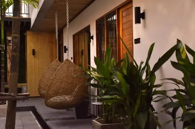 a porch with two baskets hanging from a building at Momento Bangtao Beach in Bang Tao Beach
