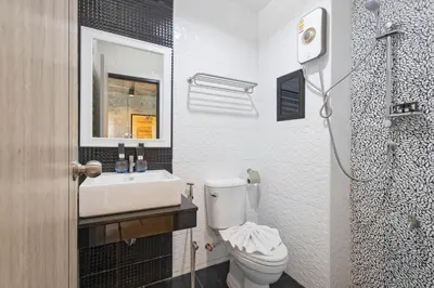 a bathroom with a toilet and a sink and a mirror at My Style Resort Hotel -SHA Plus in Patong Beach