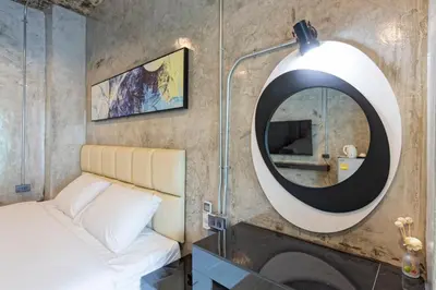 a bedroom with a mirror and a bed at My Style Resort Hotel -SHA Plus in Patong Beach