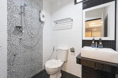 a bathroom with a toilet and a sink and a mirror at My Style Resort Hotel -SHA Plus in Patong Beach