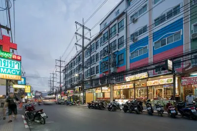 a group of motorcycles parked on the side of a street at Baan Thai Beach Side Residence, Patong Beach in Patong Beach