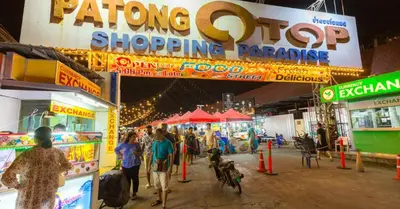 a group of people walking through a shopping arcade at Baan Thai Beach Side Residence, Patong Beach in Patong Beach