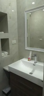 a bathroom with a white sink and a mirror at Villa Versace Residence in Patong Beach