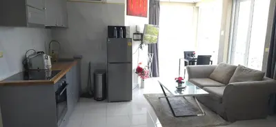 a kitchen with a couch and a chair in a kitchen at Villa Versace Residence in Patong Beach