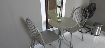 a table and chairs in a room with a mirror at Villa Versace Residence in Patong Beach