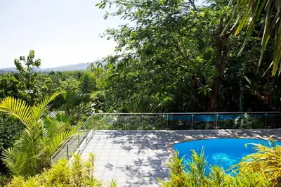 a pool in the middle of a garden with trees at Thara Bayview Villa, SHA Certified in Ao Nang Beach