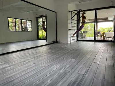a woman is doing a yoga pose in a dance studio at Thara Bayview Villa, SHA Certified in Ao Nang Beach