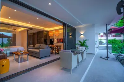 a living room with a couch and a table at Patong Heights in Patong Beach