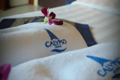 a tattoo on the side of a towel on a bed at Calypso Patong Hotel in Patong Beach