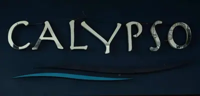 a sign that says alyon on a blue wall at Calypso Patong Hotel in Patong Beach