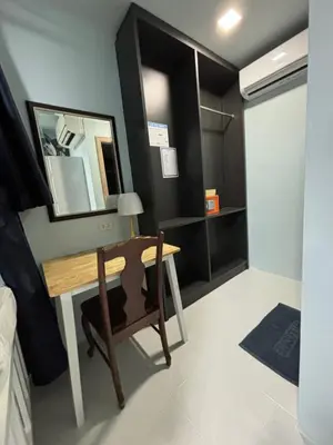 a room with a desk and a mirror on the wall at The One Hostel Phi Phi Island in Phi Phi Don