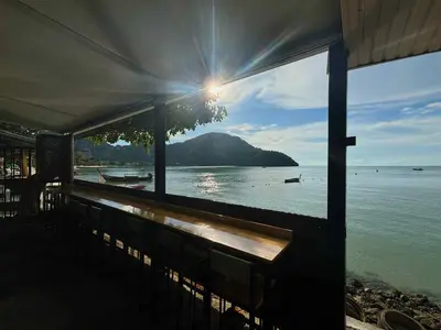 a view of the ocean from a balcony of a building at The One Hostel Phi Phi Island in Phi Phi Don