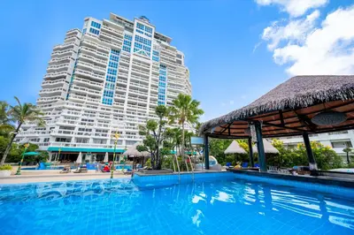 a swimming pool in front of a large building at Andaman Beach Suites Hotel, Patong Phuket in Patong Beach
