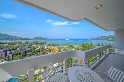 a balcony with chairs and a view of the ocean at Andaman Beach Suites Hotel, Patong Phuket in Patong Beach