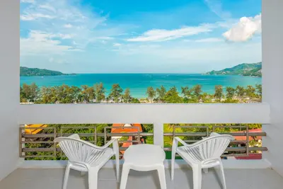 a room with a view of the ocean at Andaman Beach Suites Hotel, Patong Phuket in Patong Beach