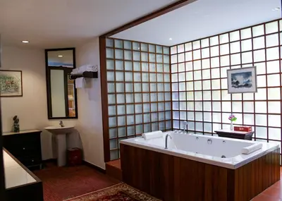 a large bathroom with a tub and a sink at Mom Tri's Villa Royale - SHA Plus in Kata Beach