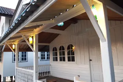 a pergola over a front porch of a house at Fisherman Guesthouse in Ko Yao Noi