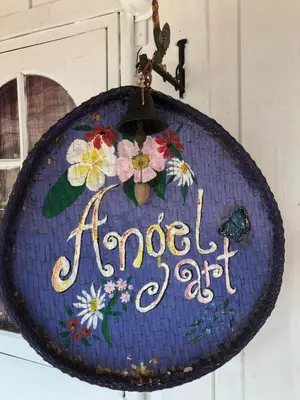 a sign that says happy art hanging on a wall at Fisherman Guesthouse in Ko Yao Noi