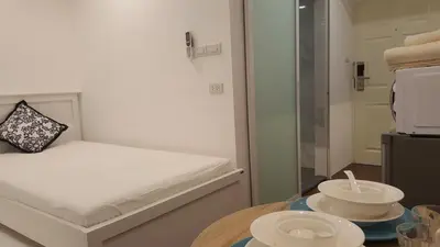 a small room with a bed and a table with a bowl at Wora Stay room Kata beach in Kata Beach