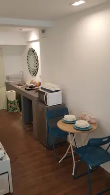a kitchen with a table and chairs and a microwave at Wora Stay room Kata beach in Kata Beach