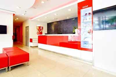 a store lobby with a red bench and a counter at Easy Planet Phuket Patong in Patong Beach