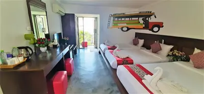 a hotel room with two beds and a table at D2 lamoon resotel in Phuket Town
