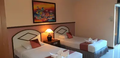 a hotel room with two beds and a picture on the wall at D2 lamoon resotel in Phuket Town