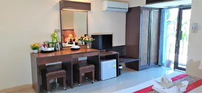 a living room with a desk and a television at D2 lamoon resotel in Phuket Town