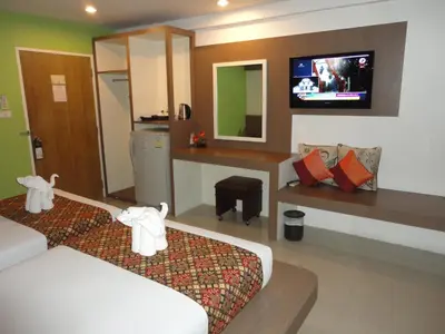 a hotel room with a bed and a tv at D2 lamoon resotel in Phuket Town