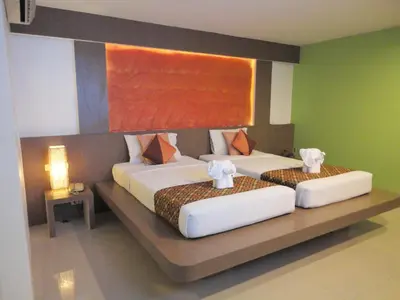 two beds in a hotel room with at D2 lamoon resotel in Phuket Town