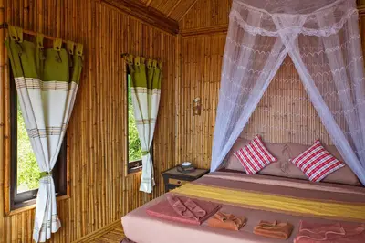 a bedroom with a bed with a mosquito net at The Cove Phi Phi in Phi Phi Don