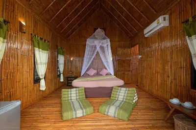 a bedroom with a bed and two chairs in a room at The Cove Phi Phi in Phi Phi Don