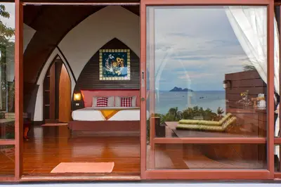a glass door of a bedroom with a bed at The Cove Phi Phi in Phi Phi Don