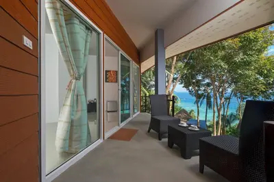 a room with a view of the ocean at The Cove Phi Phi in Phi Phi Don