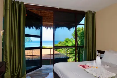 a bedroom with a window with a view of the ocean at Phi Phi Sea Sky Resort in Phi Phi Don