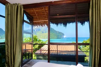 a room with a view of the ocean through a window at Phi Phi Sea Sky Resort in Phi Phi Don