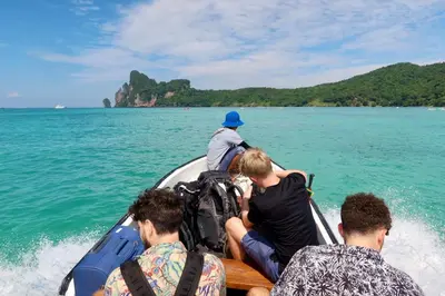 a group of people sitting on a boat in the water at Phi Phi Sea Sky Resort in Phi Phi Don