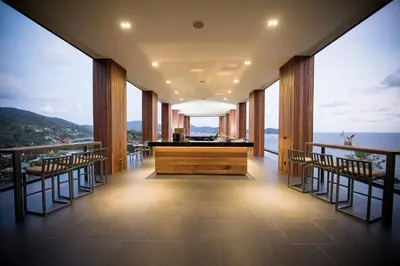 a restaurant with a view of the ocean at The Naka Phuket, a member of Design Hotels in Kamala Beach