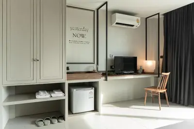 a room with a desk and a tv and a chair at Sugar Ohana Poshtel in Kata Beach